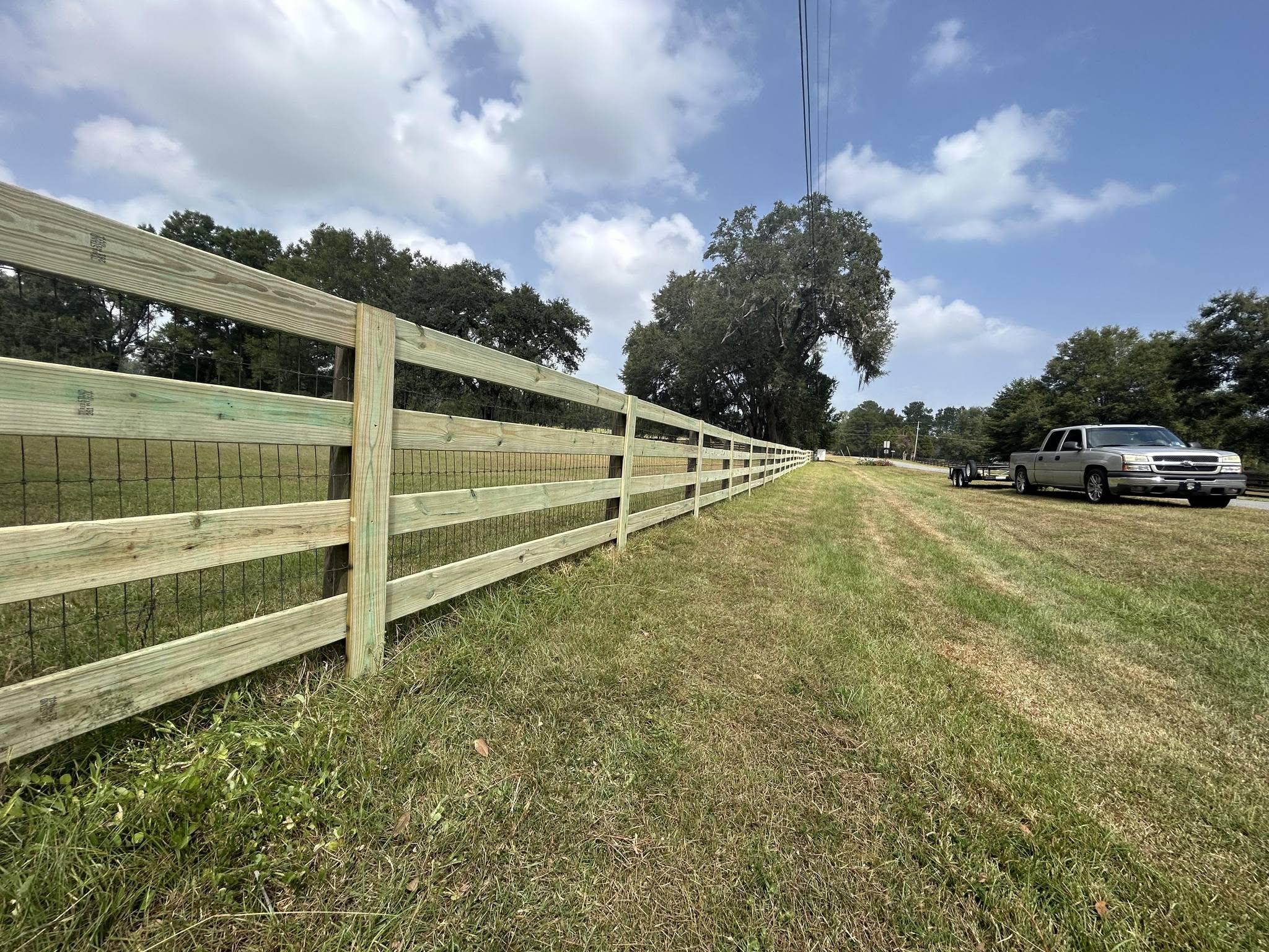Long wood post-and-rail field fence installed by Studstill Fence
