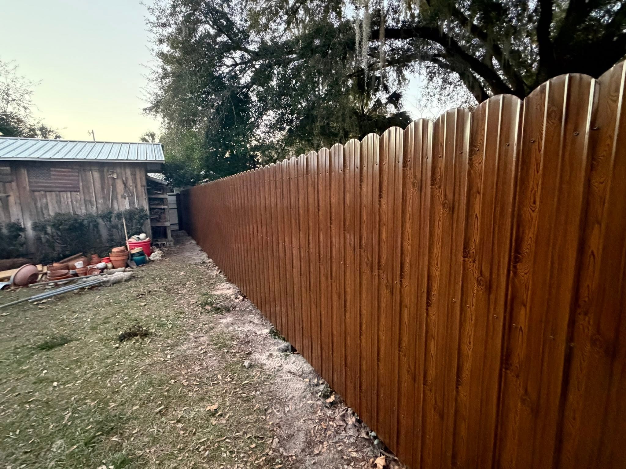 Finished dark-oak privacy fence after replacement